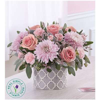Pink roses and chrysanthemums in a patterned gray vase