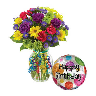Colorful mixed bouquet in a glass vase with a birthday balloon