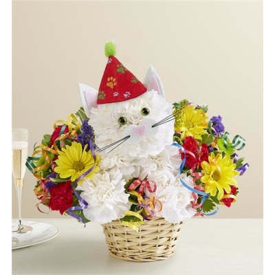 White cat-shaped flower arrangement in a basket with colorful blooms and ribbons