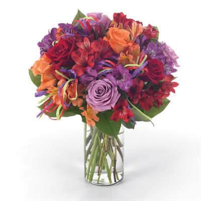 Mixed bouquet of roses and alstroemeria in a clear glass vase