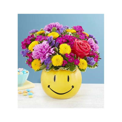 Colorful mixed flower arrangement in a yellow smiley-face container