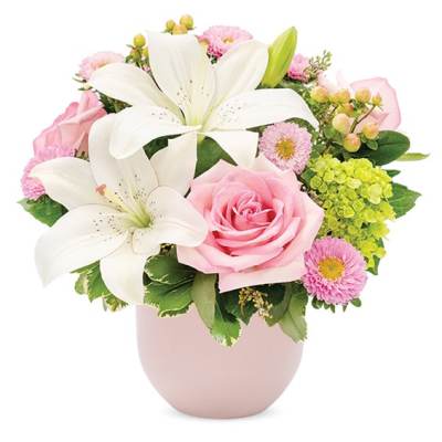 Pink and white flower arrangement in a pale pink vase