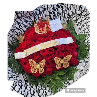 Red rose bouquet with a birthday ribbon, crown topper, and butterfly decorations