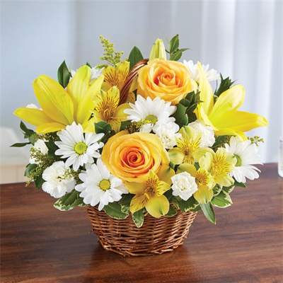 Yellow roses and white daisies in a wicker basket