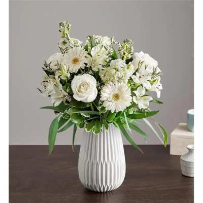 White floral bouquet in a ribbed white vase