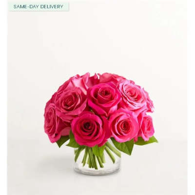 Bouquet of bright pink roses in a clear glass vase