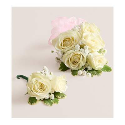 Cream rose corsage and boutonniere with pink ribbon and white filler flowers