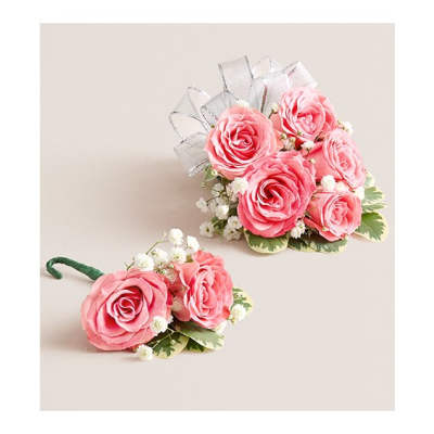 Pink rose corsage and boutonniere with white baby's breath