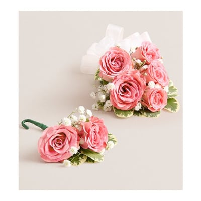 Pink rose corsage and boutonniere with white ribbon and baby's breath