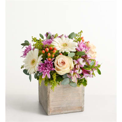 Mixed bouquet of white and pink flowers in a wooden box