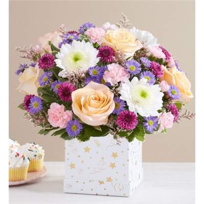 Mixed bouquet of roses, daisies, and carnations in a decorated box