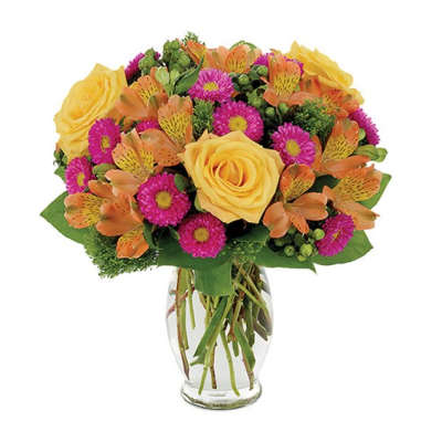 Bouquet of yellow roses, orange alstroemeria, and magenta daisies in a glass vase