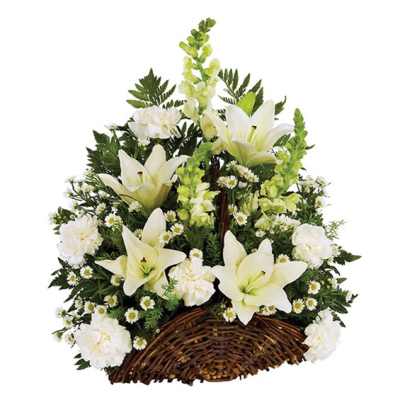 White lilies and carnations arranged in a wicker basket