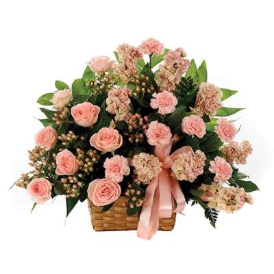 Pink roses and carnations in a wicker basket with a satin ribbon