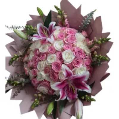 Pink and white rose bouquet with lilies wrapped in mauve paper