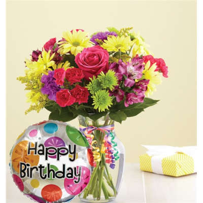Mixed bouquet in a glass vase with a birthday balloon