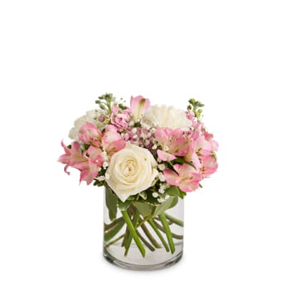 Pink and white bouquet in a clear glass vase