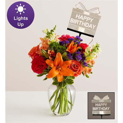 Mixed bouquet in a glass vase with a birthday sign