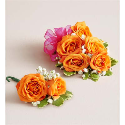 Orange rose corsages with white filler flowers and pink ribbon