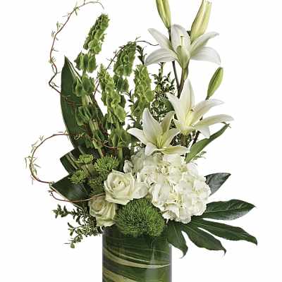 White lilies and roses in a green glass vase