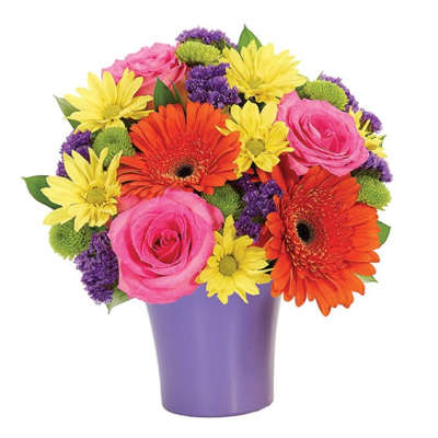 Bright mixed bouquet in a purple vase with pink roses and orange gerbera daisies