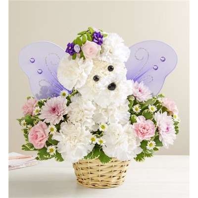 White teddy bear floral arrangement with purple wings in a wicker basket