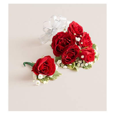 Red rose corsage and boutonniere with white ribbon and baby's breath