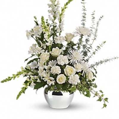 White floral arrangement in a silver vase with tall spiky blooms