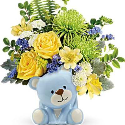 Yellow and white flower arrangement in a blue teddy bear container