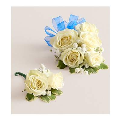 Two white rose boutonnieres with blue ribbon accents on a light background.