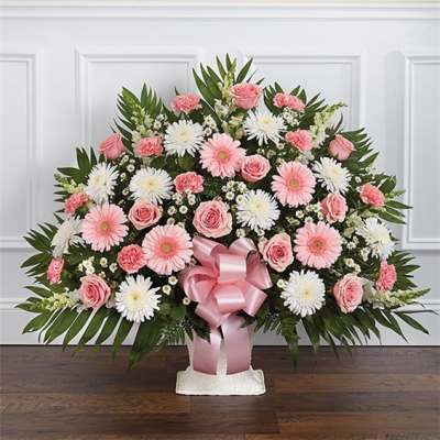 Pink and white floral spray with a pink ribbon bow