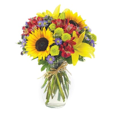Bouquet of sunflowers, lilies, and mixed flowers in a glass vase
