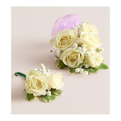 Two ivory rose corsages with small white filler flowers and purple ribbon
