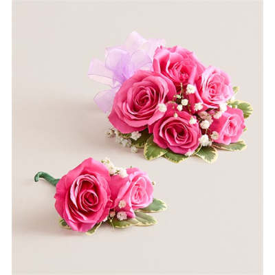 Pink rose corsage and matching boutonniere with a lavender ribbon