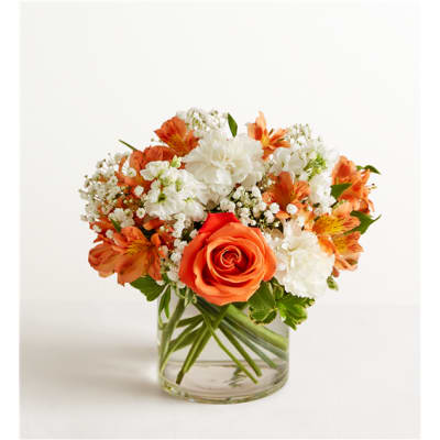 Orange and white mixed bouquet in a clear glass vase