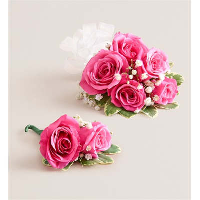 Pink rose corsage and boutonniere with white baby's breath