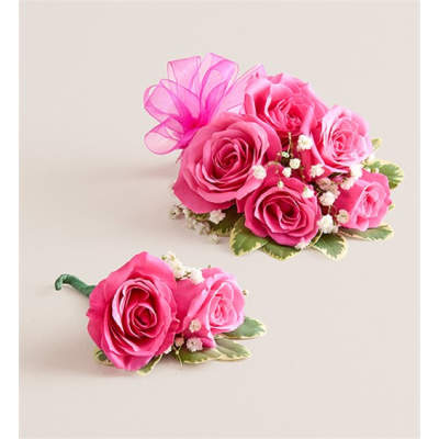 Pink rose corsage and boutonniere with small white filler flowers
