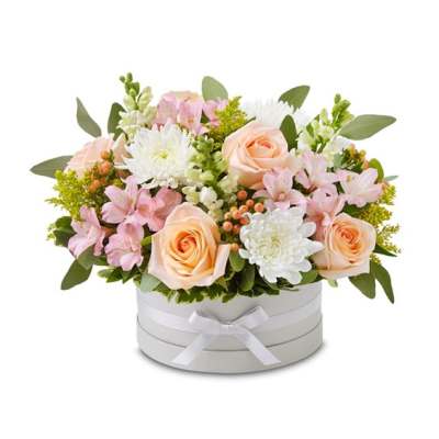 Peach roses and pink-white flowers arranged in a round white box