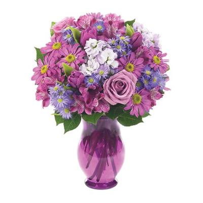 Pink and purple mixed bouquet in a purple glass vase