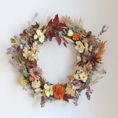 Autumn floral wreath with cream, orange, and burgundy blooms
