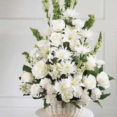 White floral arrangement in a wicker basket