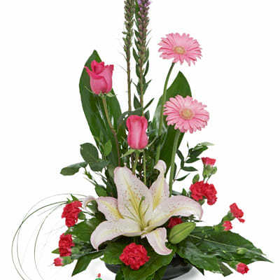 Tall floral arrangement with pink lilies, roses, gerbera daisies, and carnations