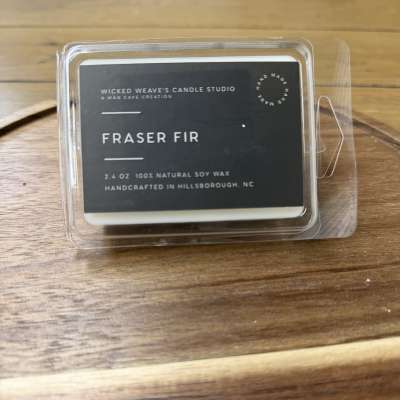 Fraser fir wax melt in a clear plastic clamshell