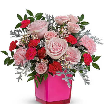 Pink and red rose arrangement in a bright pink vase