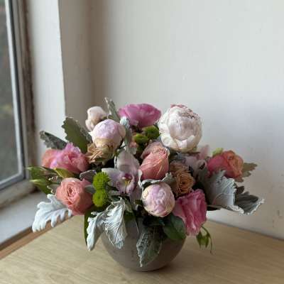 Pink and white floral arrangement in a round vase