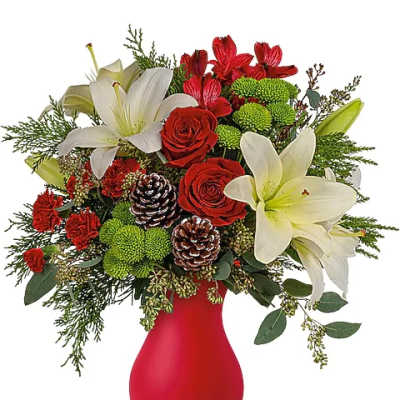 Red and white floral arrangement in a red vase with pinecones