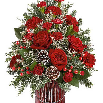 Red roses and carnations in a red glass vase with pinecones