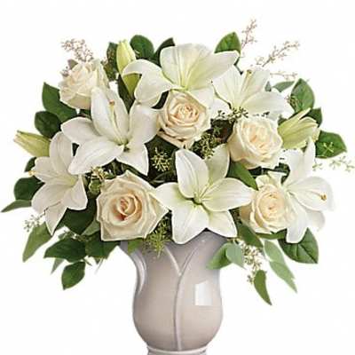White lilies and cream roses arranged in a vase