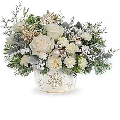 White roses and winter greenery in a snowflake vase with silver ornaments