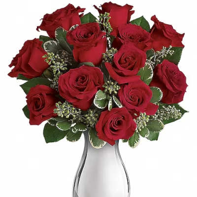 Red roses arranged in a clear glass vase